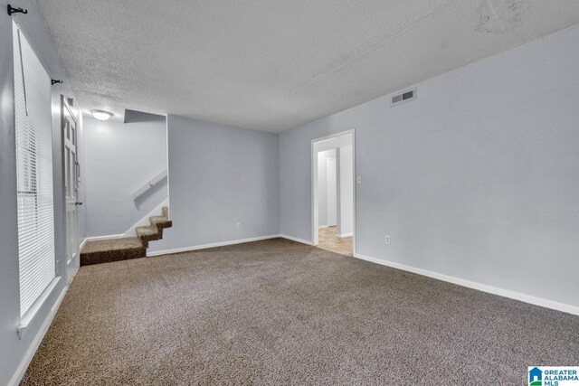 1722 6th Place Cir NW, Center Point, AL 35215 - carpeted spare room with stairs and a textured ceiling