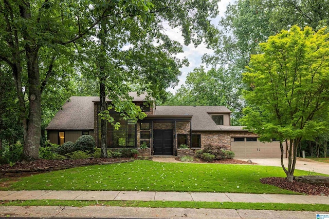 3709 Dover Dr, Mountain Brook, AL 35223 - mid-century modern home with concrete driveway, an attached garage, a front lawn, and a shingled roof