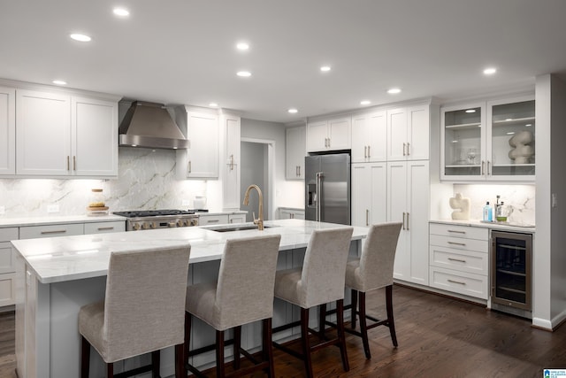 3709 Dover Dr, Mountain Brook, AL 35223 - kitchen with wall chimney range hood, beverage cooler, high end refrigerator, decorative backsplash, and recessed lighting