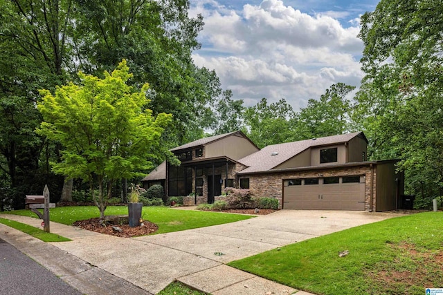 3709 Dover Dr, Mountain Brook, AL 35223 - view of front of home with stone siding, a front yard, a garage, and driveway