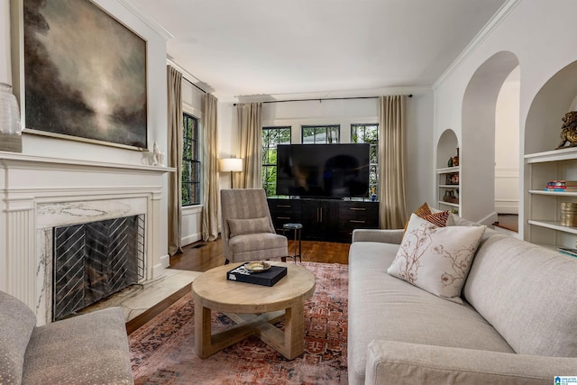 3443 Cliff Rd S, Birmingham, AL 35205 - living room featuring wood finished floors, ornamental molding, built in features, and a fireplace
