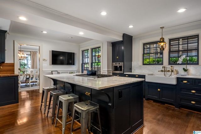 3443 Cliff Rd S, Birmingham, AL 35205 - kitchen featuring stainless steel appliances, a chandelier, dark wood-type flooring, crown molding, and a breakfast bar