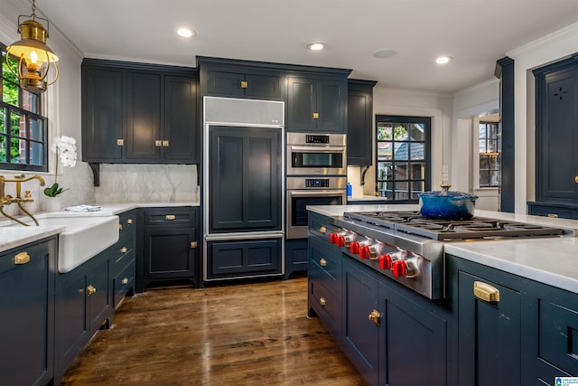 3443 Cliff Rd S, Birmingham, AL 35205 - kitchen with stainless steel appliances, ornamental molding, dark wood-style flooring, light countertops, and pendant lighting