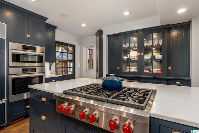3443 Cliff Rd S, Birmingham, AL 35205 - kitchen with light countertops, glass insert cabinets, ornamental molding, recessed lighting, and dark wood-style floors