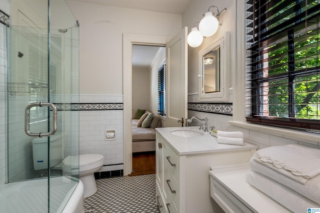 3443 Cliff Rd S, Birmingham, AL 35205 - full bath with tile walls, vanity, an enclosed shower, and a wainscoted wall