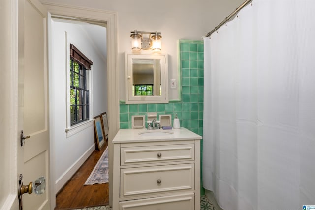 3443 Cliff Rd S, Birmingham, AL 35205 - full bath with vanity, wood finished floors, tile walls, and curtained shower