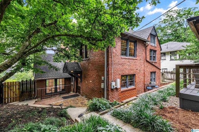 3443 Cliff Rd S, Birmingham, AL 35205 - back of house with brick siding, roof with shingles, and a gate