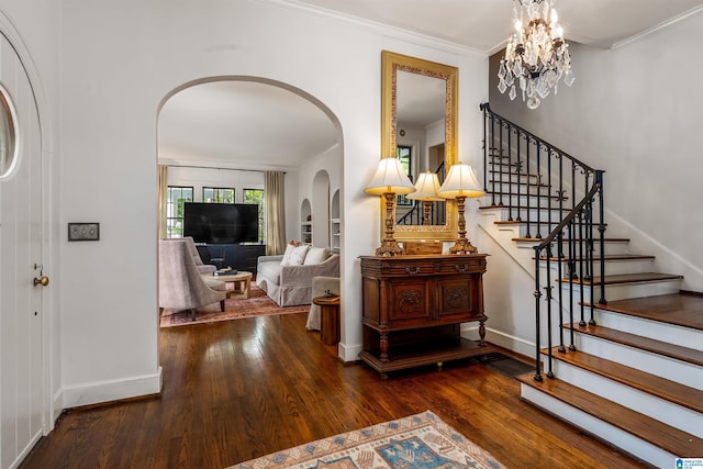 3443 Cliff Rd S, Birmingham, AL 35205 - entrance foyer featuring wood finished floors, stairs, arched walkways, ornamental molding, and a chandelier