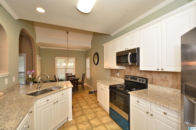 401 Waterford Highlands Way, Calera, AL 35040 - kitchen with appliances with stainless steel finishes, backsplash, white cabinets, pendant lighting, and arched walkways
