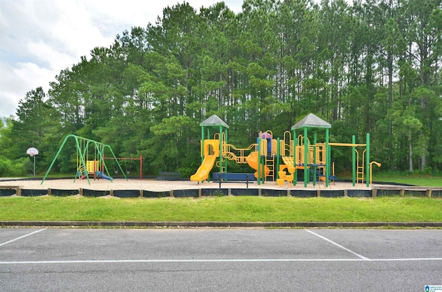 401 Waterford Highlands Way, Calera, AL 35040 - community play area featuring a lawn and view of wooded area