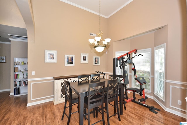401 Waterford Highlands Way, Calera, AL 35040 - dining area featuring ornamental molding, wood finished floors, a chandelier, and a high ceiling