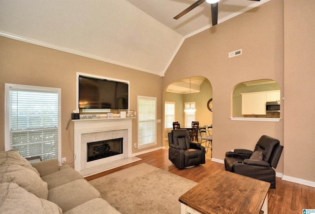 401 Waterford Highlands Way, Calera, AL 35040 - living area featuring ceiling fan, vaulted ceiling, arched walkways, wood finished floors, and ornamental molding