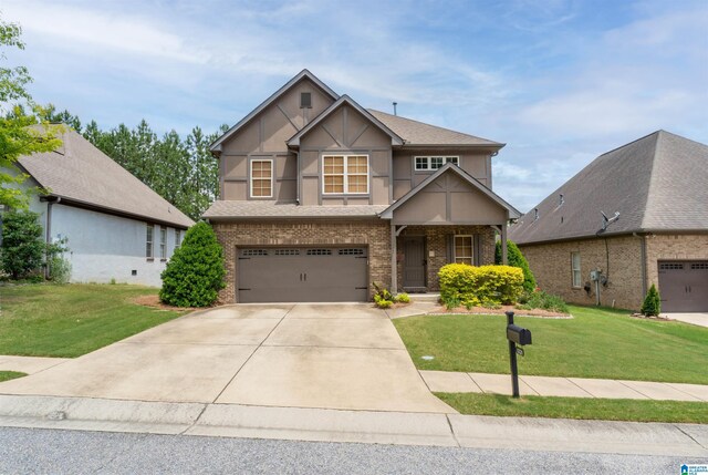 1221 Grants Way, Irondale, AL 35210 - view of front of property featuring brick siding, an attached garage, driveway, a front lawn, and stucco siding