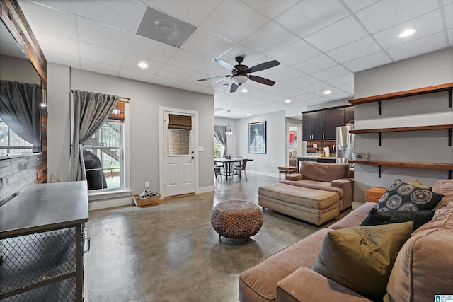 1221 Grants Way, Irondale, AL 35210 - living room featuring concrete floors, a ceiling fan, and a drop ceiling