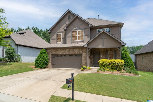 1221 Grants Way, Irondale, AL 35210 - view of front of home with brick siding, a front yard, a garage, concrete driveway, and stucco siding