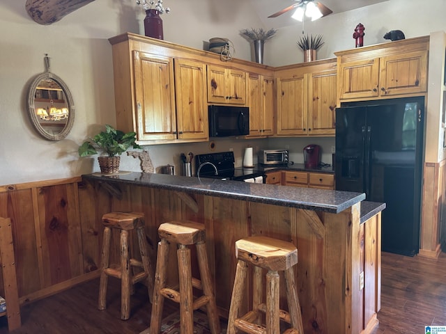 26718 Bridge Ln, Andalusia, AL 36421 - kitchen featuring black appliances, ceiling fan, a peninsula, dark countertops, and dark wood finished floors
