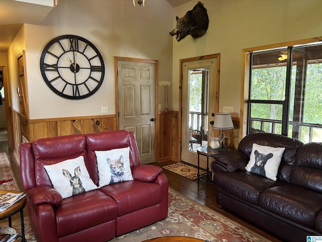 26718 Bridge Ln, Andalusia, AL 36421 - living room featuring a wainscoted wall, wood finished floors, wooden walls, and a high ceiling