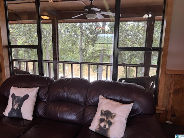 26718 Bridge Ln, Andalusia, AL 36421 - living room with ceiling fan, wood walls, healthy amount of natural light, and a wainscoted wall