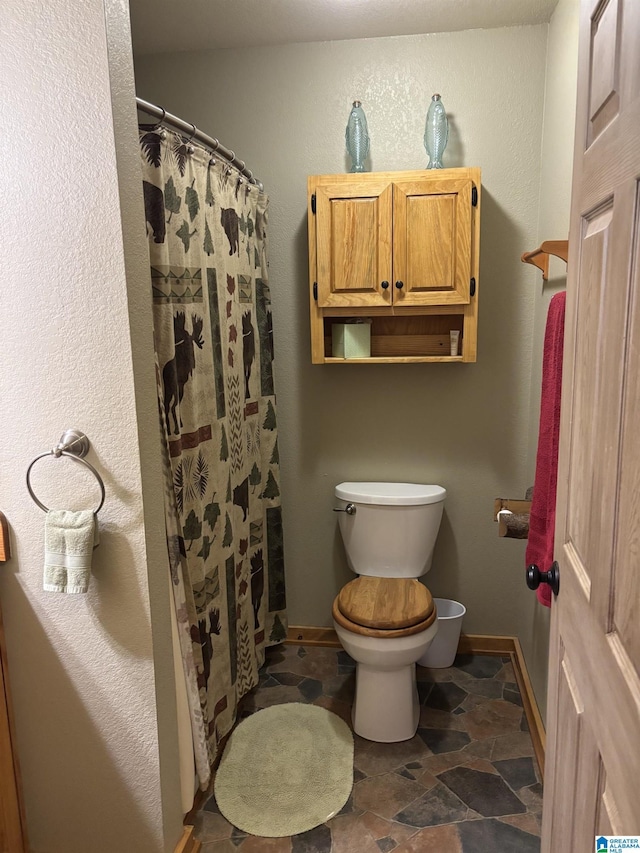 26718 Bridge Ln, Andalusia, AL 36421 - bathroom with stone finish floors and curtained shower