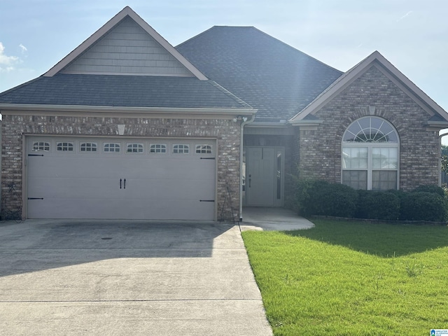 2007 Discovery Dr, Montevallo, AL 35115 - view of front of house with driveway, a garage, brick siding, a front yard, and roof with shingles