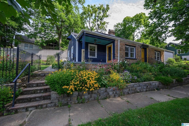 5100 7th Ct S, Birmingham, AL 35212 - view of front of property with a chimney, a porch, and stone siding