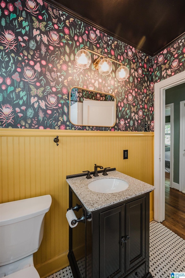 5100 7th Ct S, Birmingham, AL 35212 - bathroom featuring wainscoting, wallpapered walls, and vanity