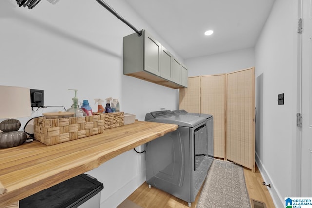 6400 Glenview Cir, Gardendale, AL 35071 - laundry area with washing machine and dryer, light wood-type flooring, cabinet space, and recessed lighting