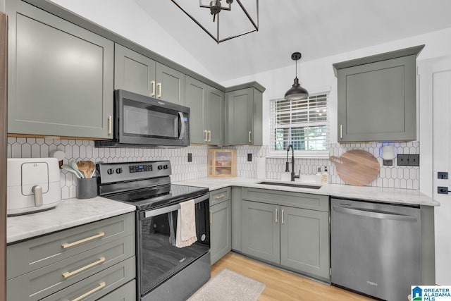 6400 Glenview Cir, Gardendale, AL 35071 - kitchen with appliances with stainless steel finishes, light wood finished floors, decorative backsplash, gray cabinetry, and lofted ceiling