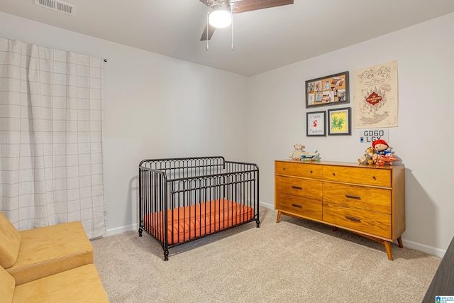 8681 Mohring Pl, Leeds, AL 35094 - carpeted bedroom with a crib and a ceiling fan