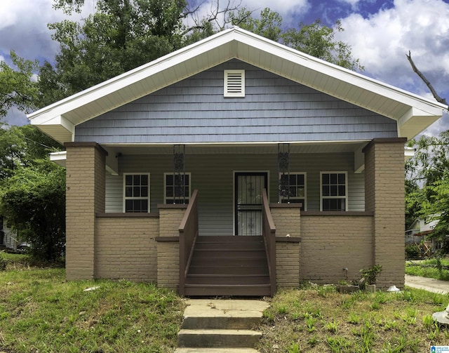 2129 Pike Rd, Birmingham, AL 35218 - bungalow-style home featuring covered porch and brick siding