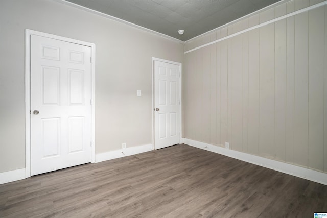 2129 Pike Rd, Birmingham, AL 35218 - unfurnished bedroom with wood finished floors and wood walls