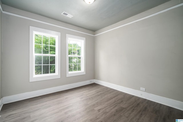 2129 Pike Rd, Birmingham, AL 35218 - spare room featuring dark wood-style flooring and baseboards
