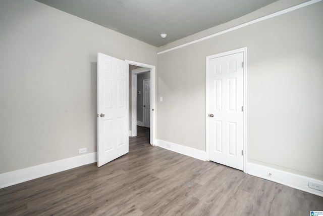 2129 Pike Rd, Birmingham, AL 35218 - empty room with wood finished floors and baseboards