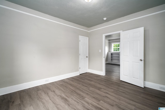 2129 Pike Rd, Birmingham, AL 35218 - spare room with wood finished floors, a textured ceiling, and a smoke detector