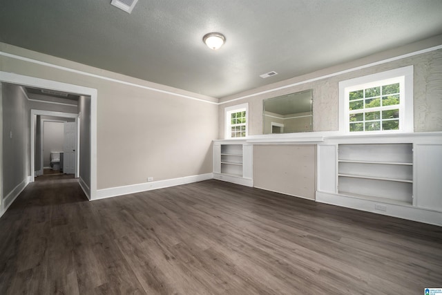 2129 Pike Rd, Birmingham, AL 35218 - unfurnished living room with healthy amount of natural light, dark wood finished floors, and a textured ceiling