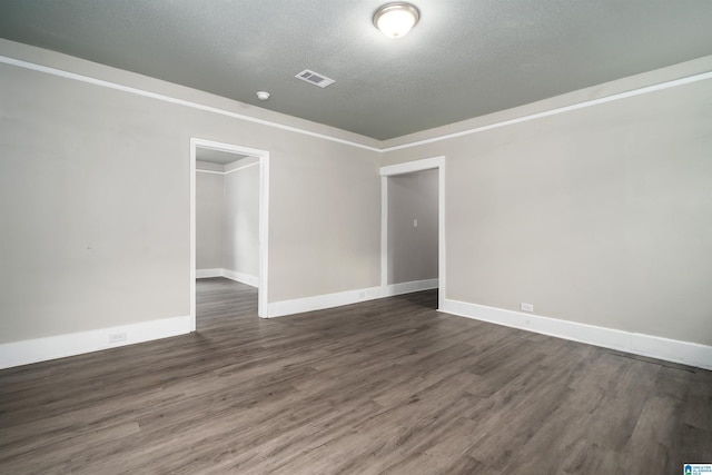 2129 Pike Rd, Birmingham, AL 35218 - spare room featuring dark wood-type flooring and a textured ceiling