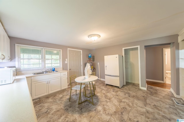 2242 3rd Ave S, Irondale, AL 35210 - kitchen with white appliances, white cabinets, and light countertops