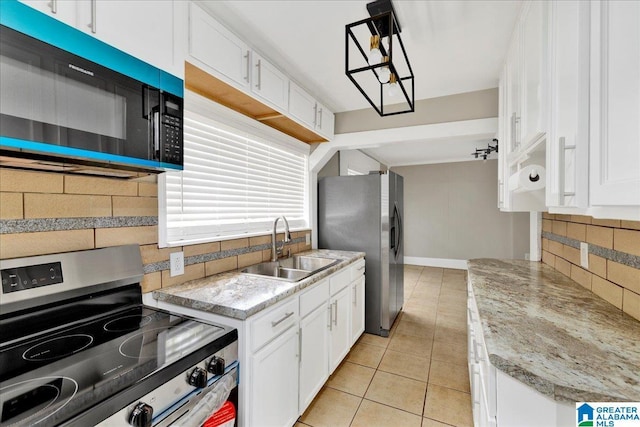 1125 SW 15th St, Birmingham, AL 35211 - kitchen featuring appliances with stainless steel finishes, light tile patterned floors, tasteful backsplash, and white cabinets