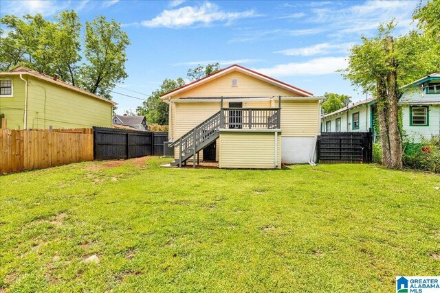 1125 SW 15th St, Birmingham, AL 35211 - back of house with stairway, a fenced backyard, and a wooden deck