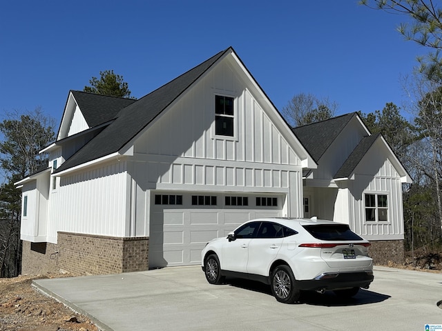 7733 Springer Rd, Mccalla, AL 35111 - view of side of property featuring board and batten siding, driveway, brick siding, and roof with shingles