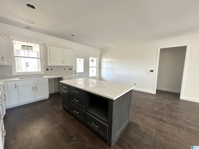 7733 Springer Rd, Mccalla, AL 35111 - kitchen featuring white cabinets, ornamental molding, dark wood-style flooring, tasteful backsplash, and dark cabinetry