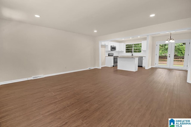 532 Hickory St, Birmingham, AL 35206 - unfurnished living room featuring dark wood finished floors, recessed lighting, and french doors