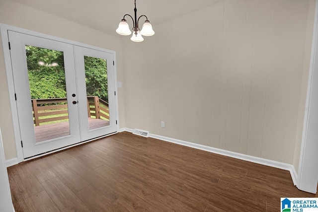 532 Hickory St, Birmingham, AL 35206 - unfurnished dining area featuring french doors, dark wood-type flooring, and a chandelier