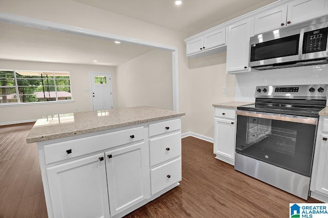 532 Hickory St, Birmingham, AL 35206 - kitchen featuring stainless steel appliances, white cabinets, dark wood-style flooring, recessed lighting, and light stone counters