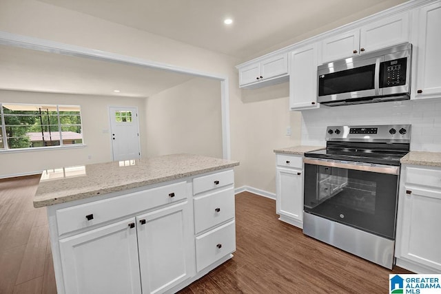 532 Hickory St, Birmingham, AL 35206 - kitchen featuring stainless steel appliances, decorative backsplash, white cabinets, dark wood finished floors, and recessed lighting