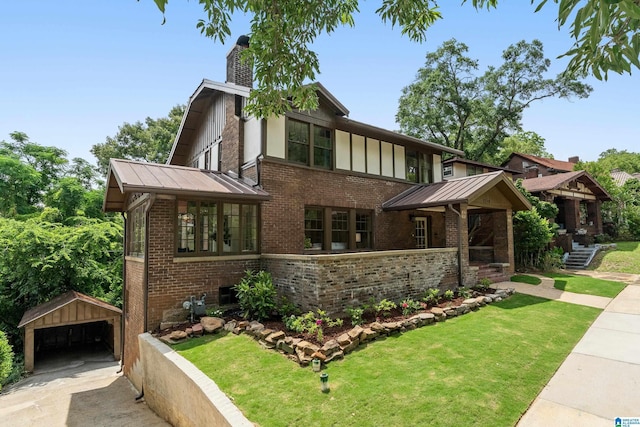 2719 Hanover Cir S, Birmingham, AL 35205 - tudor-style house with an outdoor structure, a detached garage, brick siding, and a chimney