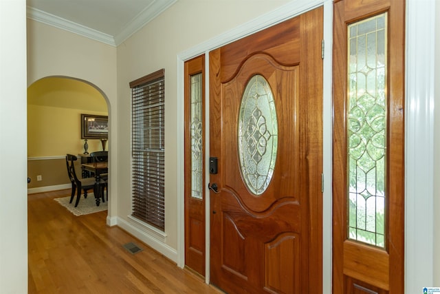 8587 Hayes Rd, Helena, AL 35022 - foyer entrance with arched walkways, wood finished floors, and ornamental molding