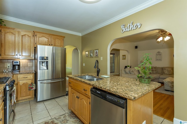 8587 Hayes Rd, Helena, AL 35022 - kitchen with appliances with stainless steel finishes, light tile patterned floors, arched walkways, ornamental molding, and open floor plan