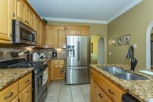 8587 Hayes Rd, Helena, AL 35022 - kitchen with appliances with stainless steel finishes, arched walkways, crown molding, light tile patterned flooring, and light stone countertops