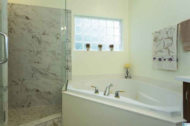 8587 Hayes Rd, Helena, AL 35022 - full bathroom featuring a garden tub, tiled shower, vanity, and marble look tile flooring